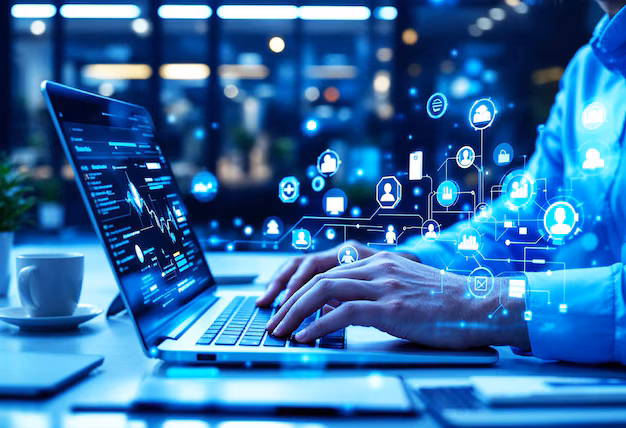 IT professional using a laptop with cybersecurity and digital network icons displayed on screen.